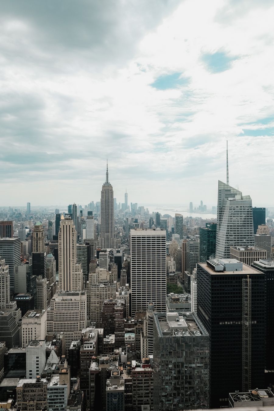 manhattan cityscape with skyscrapers — The rental desk handshake: confirmation email open, license photo ready.