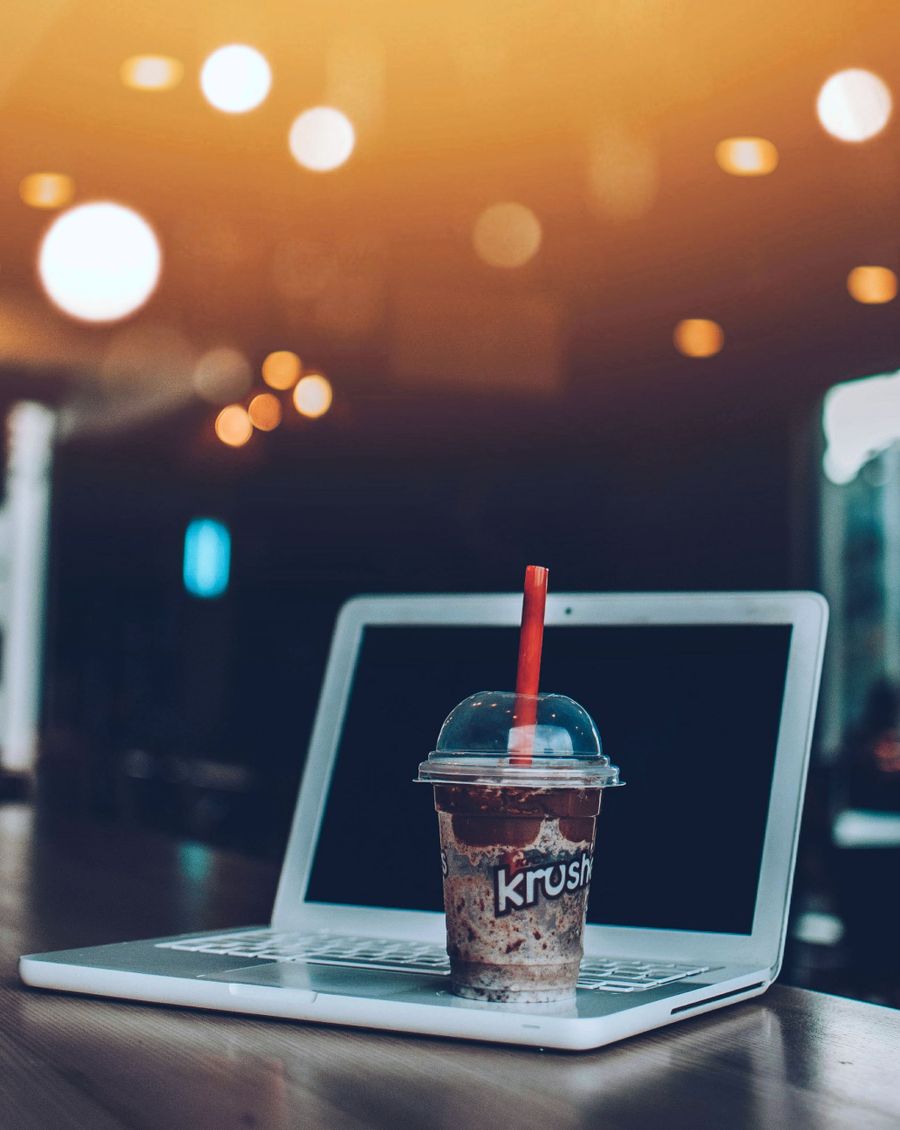 smoothie on top of white laptop computer — Real journeys, real connectivity — this is what the product is for.