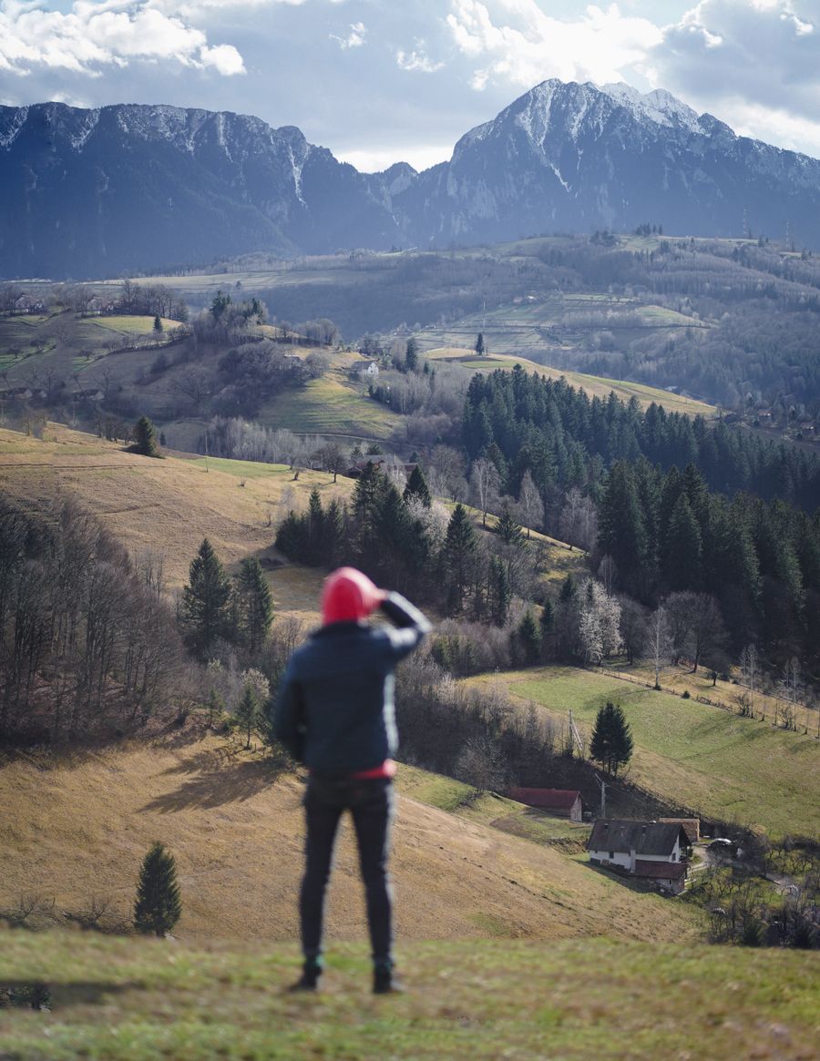 man standing with mountains behind