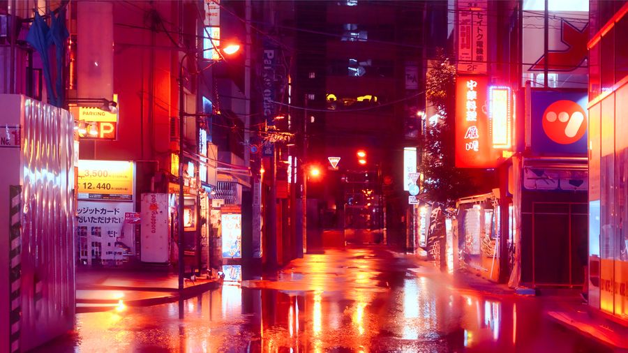 night city street after rain illuminated by colorful neon signs reflecting on a wet road
