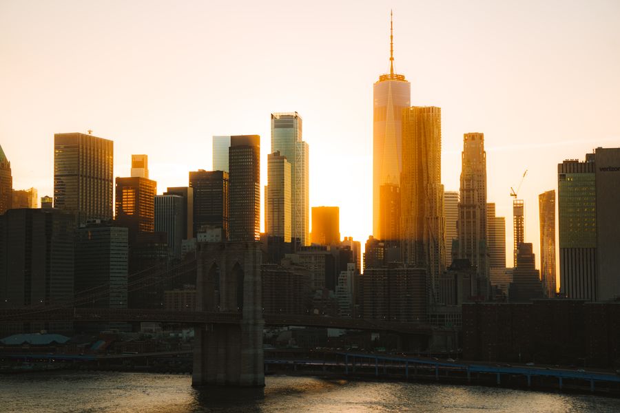 rising sun behind nyc downtown — Souvenir hunting with live currency conversion in your pocket.