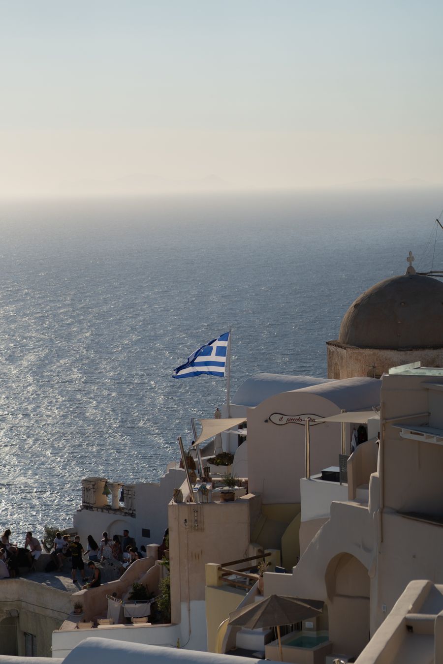 a view of a beach with a greek flag flying — eSIM Installation Guide: answers first, never a signup wall.