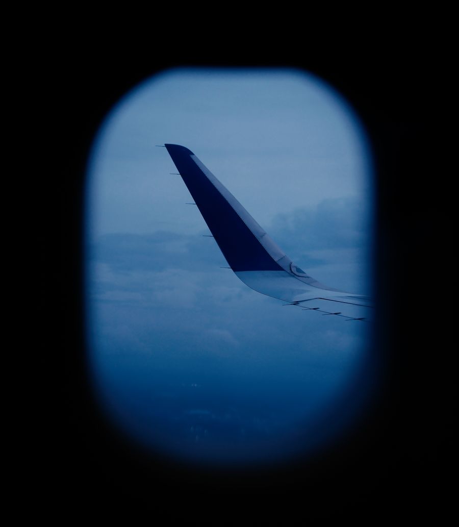 aerial view of airplane wing through window — Free Internet Speed Test: answers first, never a signup wall.
