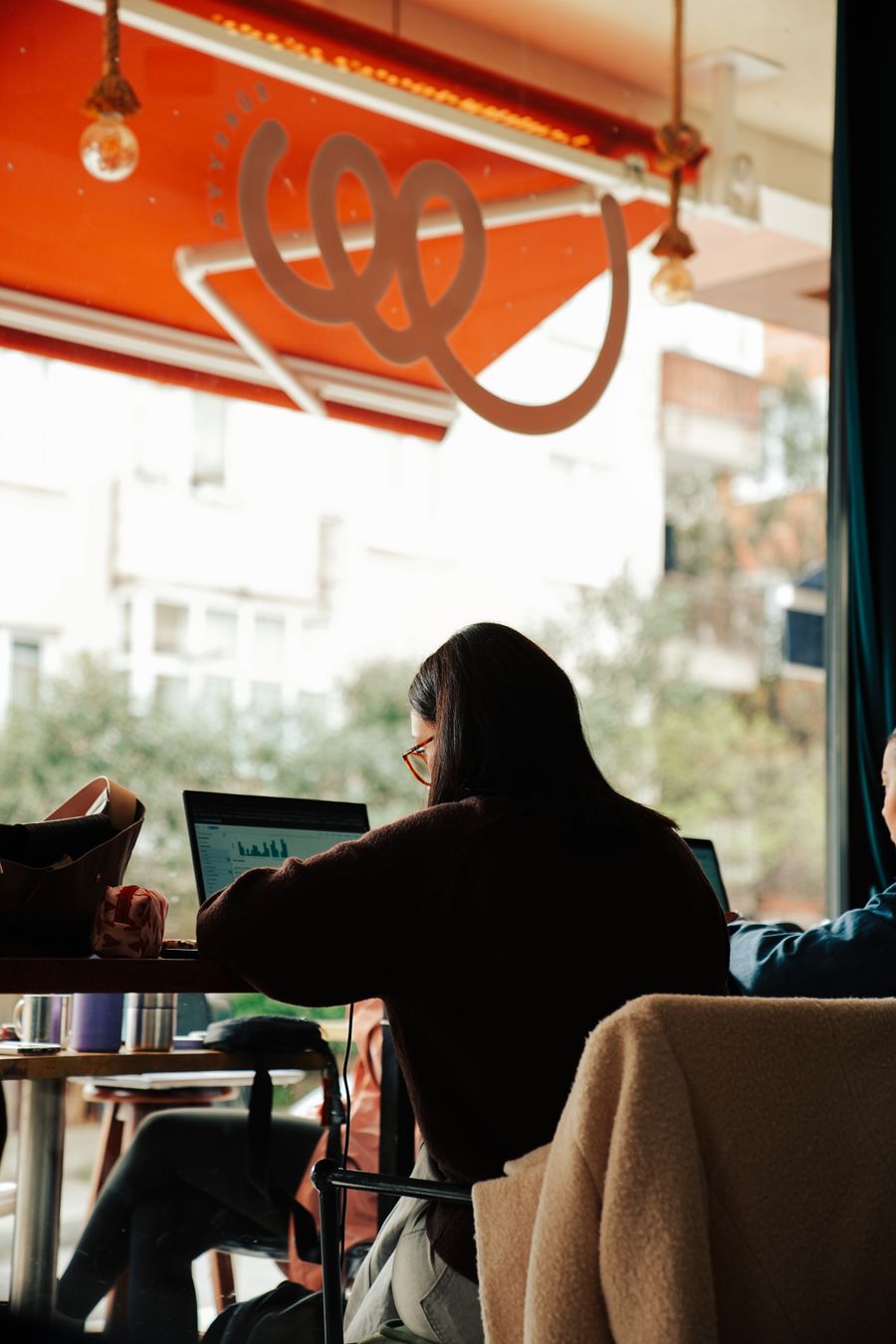 people working on laptops in a cozy cafe