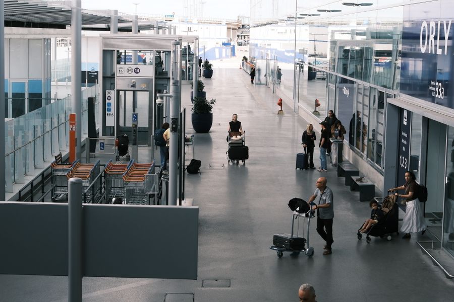 busy airport terminal with travelers and luggage — Connection Quality Grader accepts your trip details and hands back a clear recommendation.