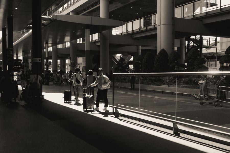 travelers with luggage at modern airport terminal — My Active eSIMs: one question, answered well, instead of ten open tabs.
