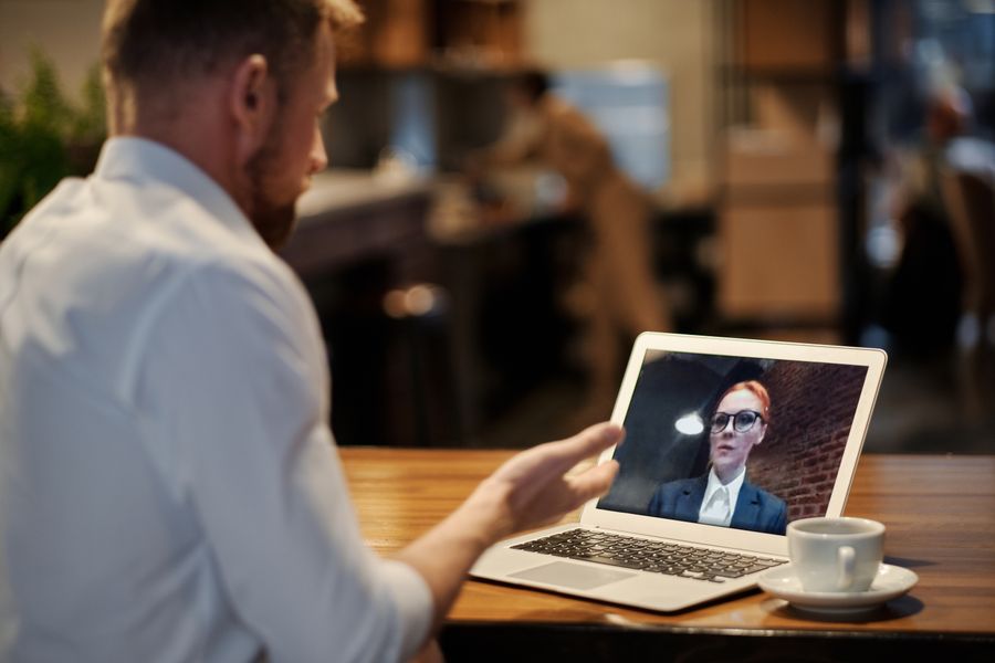 man in white dress shirt using a laptop — Coverage Checker: tell it about the trip, get the answer in under a minute.