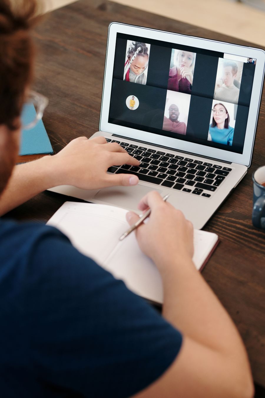 man in blue shirt having a virtual meeting
