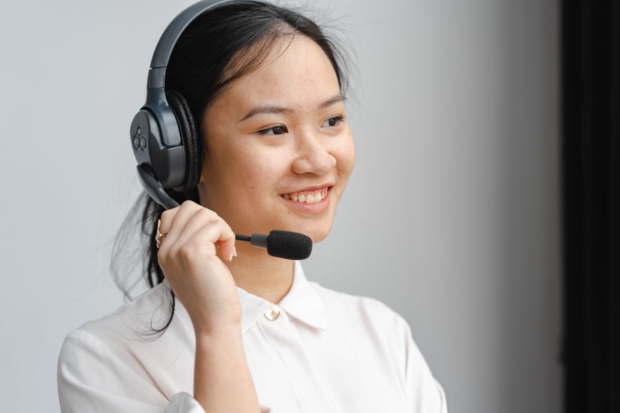 close up photo of a woman holding the microphone of her black headset — The capability matrix lists everything Carrier-Lock Check does — no asterisks.