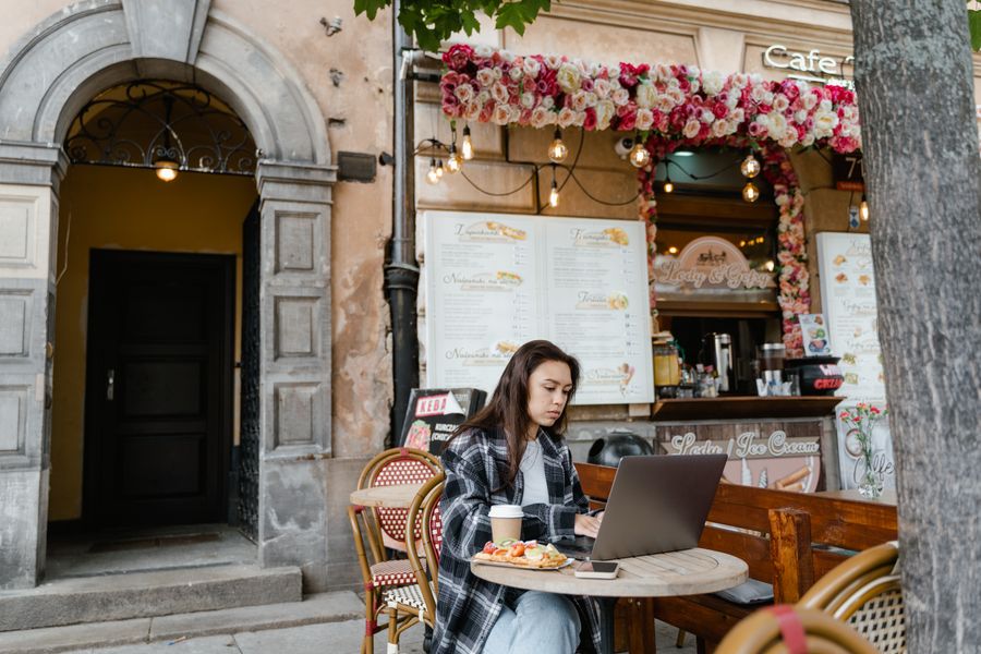 woman using laptop at a cafe — Campagne en Madagascar : la ferme trouvée, le code du portail dans les messages.