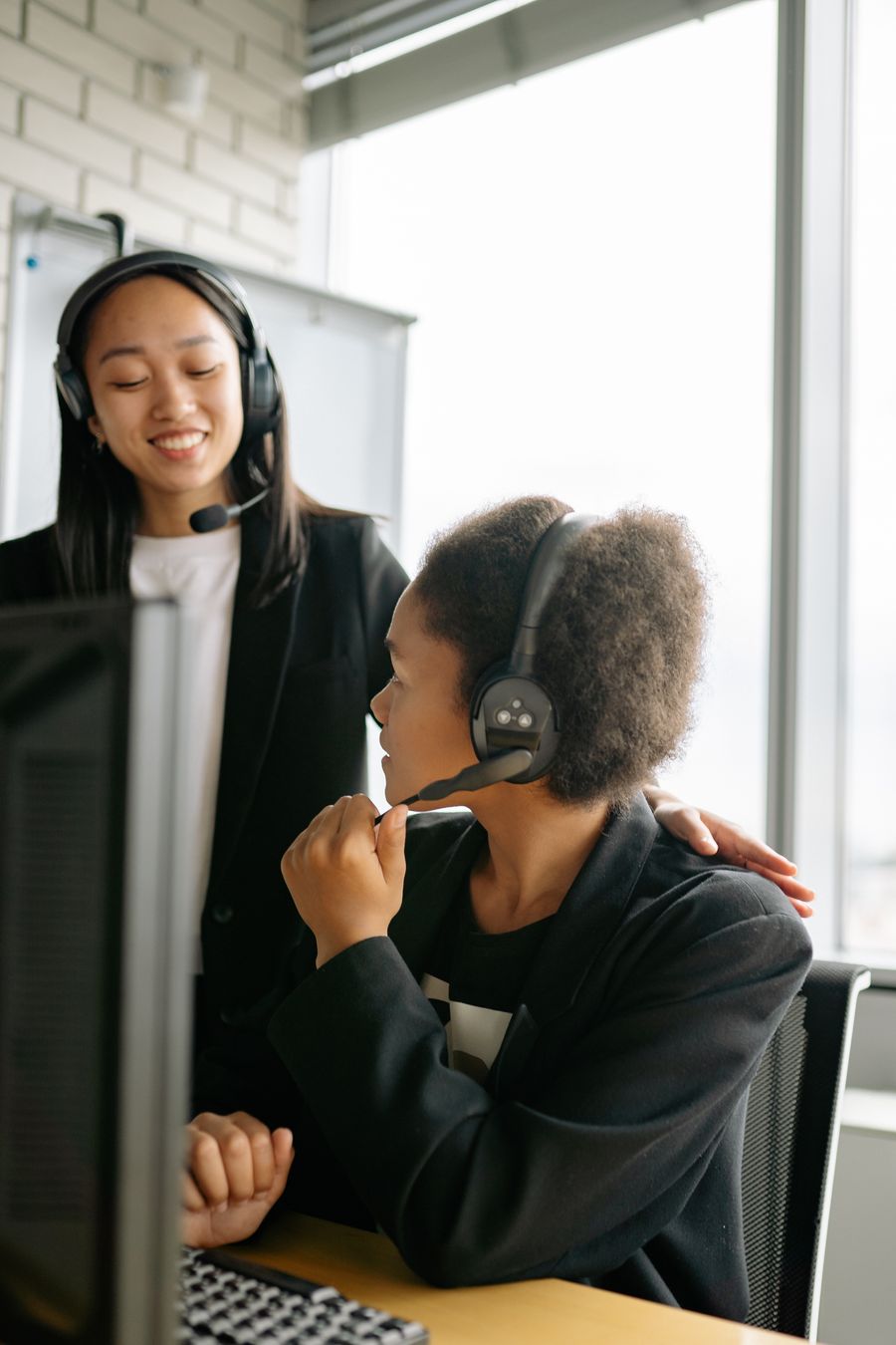 woman in black long sleeve shirt using headphones