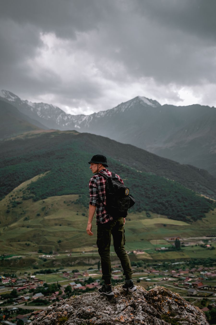 male hiker standing on the rock overlooking the green mountains — Use it while planning, at the gate, or mid-trip — it takes under a minute.